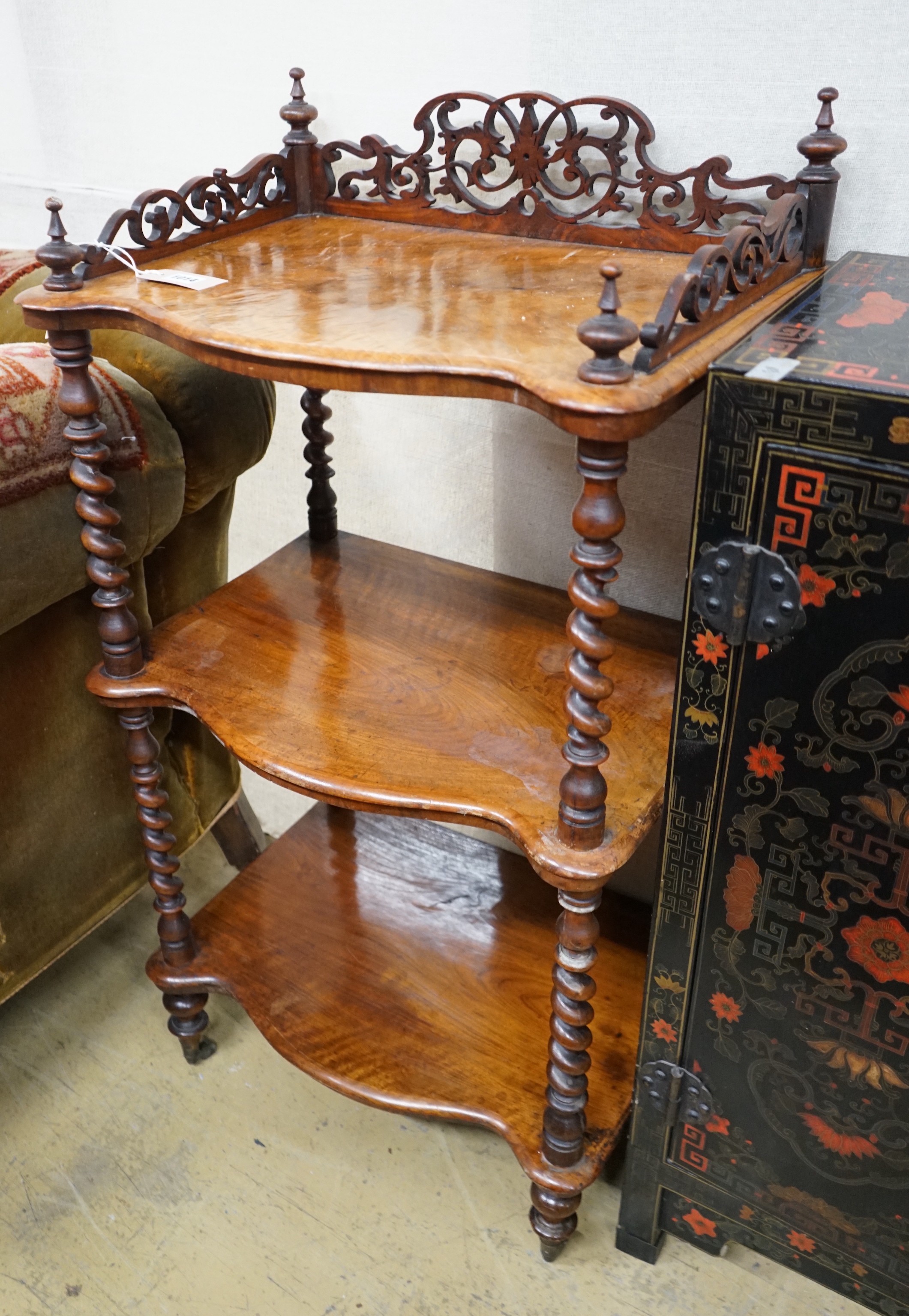 A Victorian walnut serpentine three tier whatnot, width 54cm, depth 38cm, height 104cm